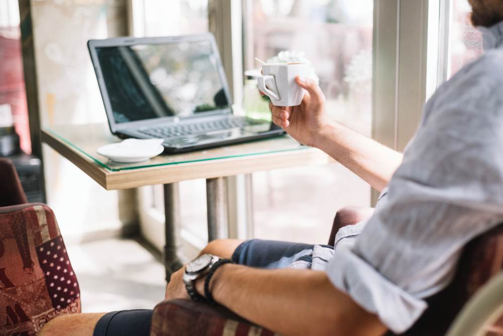 crop-man-with-coffee-cup-cafe